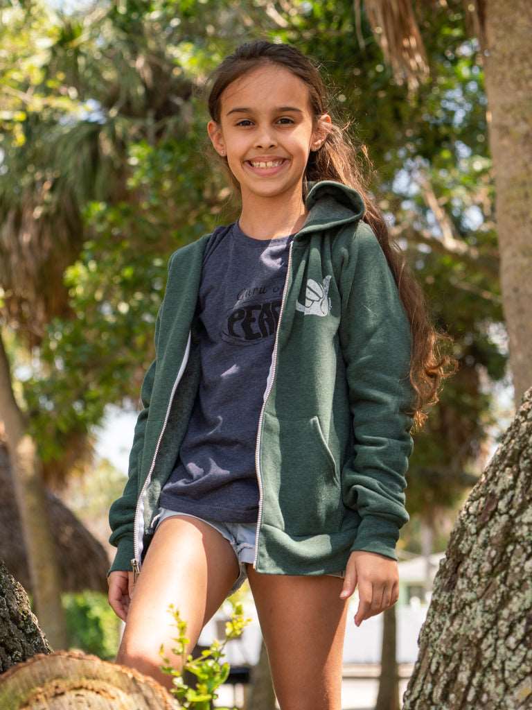 Girl wearing a forest green zip up hoodie with a hang loose sign on the side
