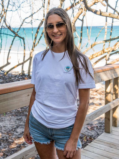 Man wearing a white t-shirt with 'Hang Loose' logo on the beach