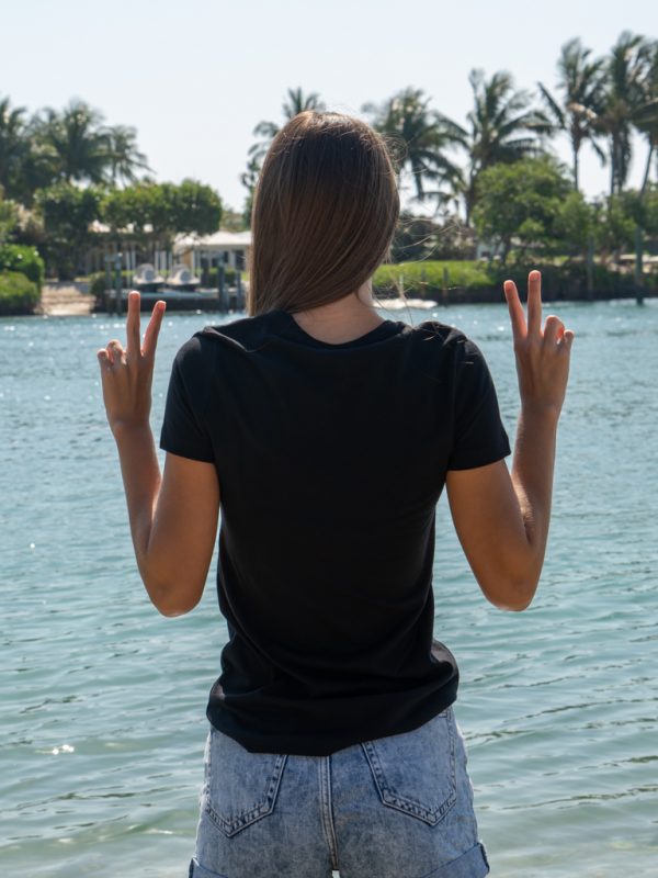 Person wearing a black t-shirt by the water