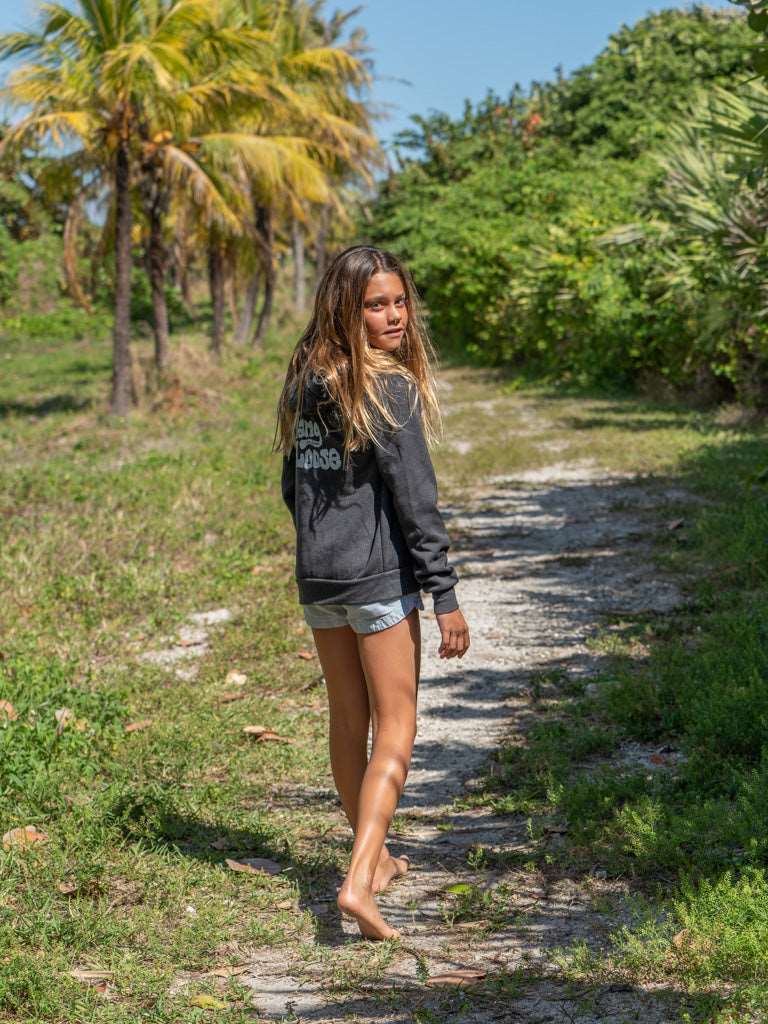 Girl wearing black hang loose hoodie with the words 'Hang Loose'