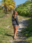 Girl wearing black hang loose hoodie with the words 'Hang Loose'