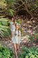 Two young girls wearing a long sleeve shirt with the words 'Guru of Peace' walking in a forest setting